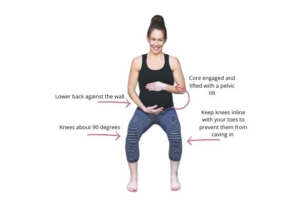 pregnant mom doing a wall squat exercise 