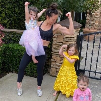 mom showing strong arms with her daughters