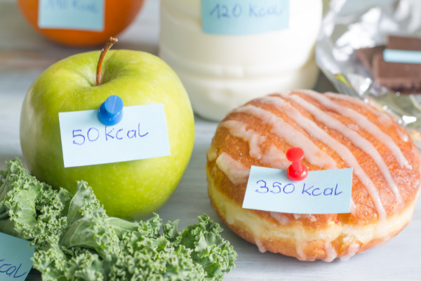 a green apple and donut with calorie information 