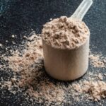 chocolate protein powder with a dark background