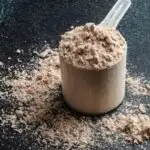 chocolate protein powder with a dark background