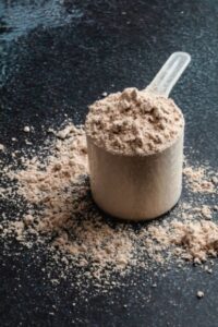 chocolate protein powder with a dark background