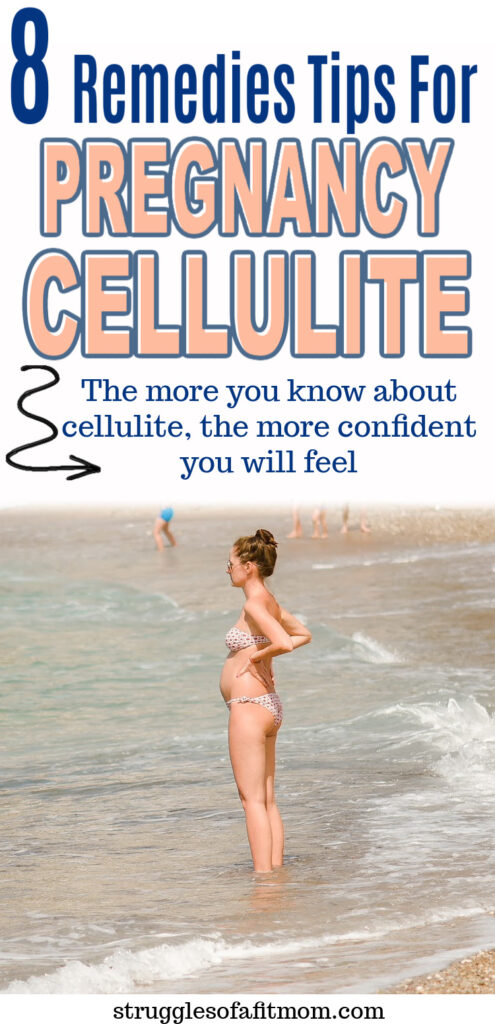 A pregnant mom in a white polka dot bikini with her hands on her hips standing in the ocean gazing out into the water.