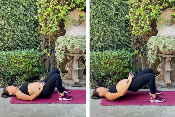 Fit pregnant mom in her third trimester doing a glute bridge. She is lying on her back on a pink yoga mat outside wearing black pants and a black sports bra. 