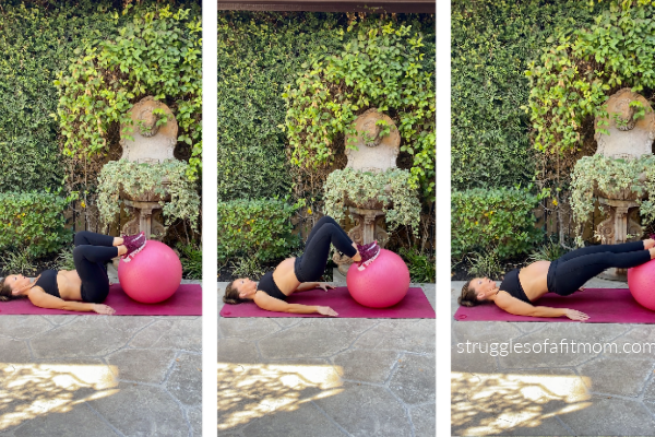 Fit pregnant mom in her third trimester doing a stability ball hamstring curl. she is lying down on a pink yoga mat outside. she is wearing black pants and a black sports bra. 
